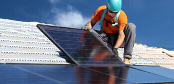 Gibson team member installing solar panels