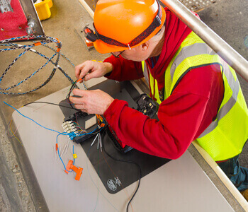 Gibson electrician working on a custom telecommunications installation